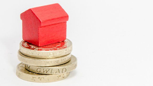 Toy house on pound coins