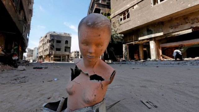 A mannequin stands near destroyed buildings in the Yarmuk Palestinian refugee camp in the Syrian capital Damascus as the regime began to clean the wreckage from the camp on October 09, 2018.