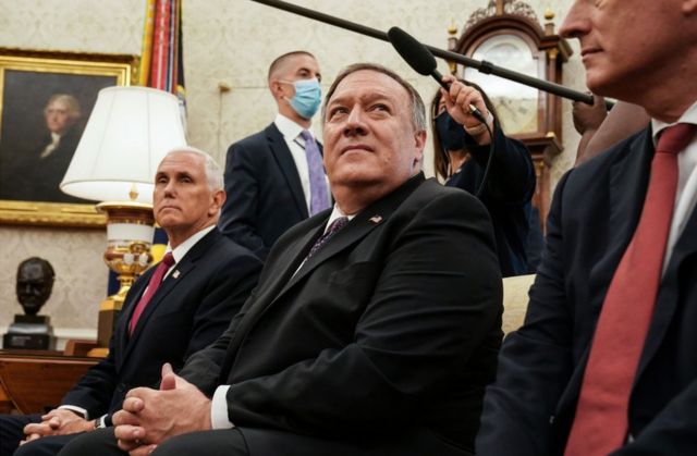Former Vice-President Mike Pence sits with then Secretary of State Mike Pompeo in August 2020