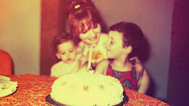 A vintage looking image recreation of a mother and her children on the daughter's first birthday