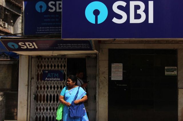 A woman in front of the bank branch of the State Bank of India (SBI) in Mumbai, India, on March 29, 2019.