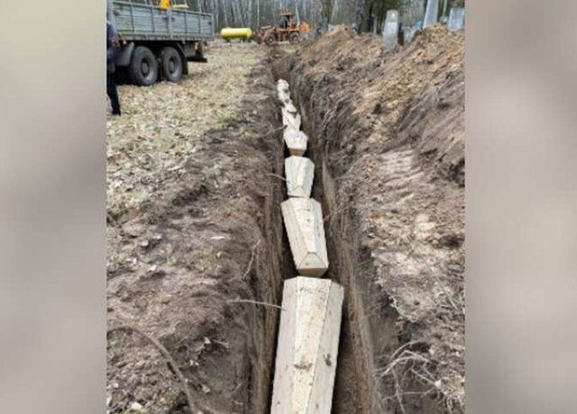 Coffins buried in a trench in Chernihiv
