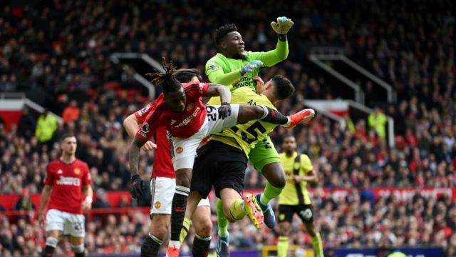 Manchester United goalkeeper André Onana fouls Zeki Amdouni of Burnley to concede a penalty kick during the Premier League match between Manchester United and Burnley FC at Old Trafford 