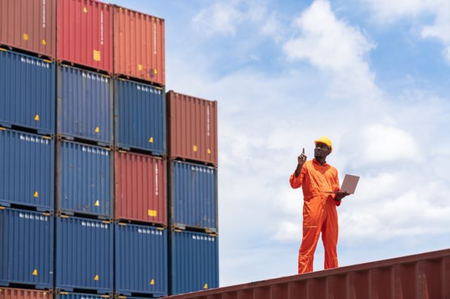 A man counts the containers