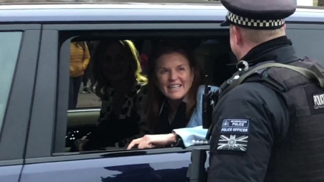Sarah Ferguson in a car being driven into the grounds of Buckingham Palace