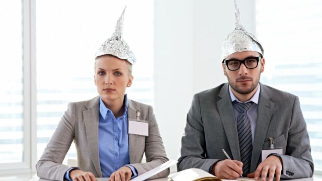 Woman and man wearing tinfoil hats