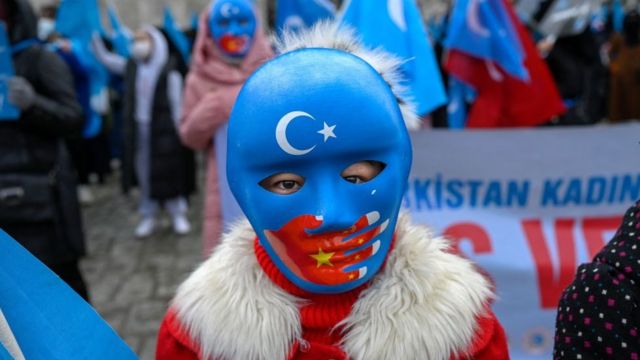 Un niño uigur que vive en Turquía usa una máscara durante una protesta contra la visita del Ministro de Relaciones Exteriores de China a Turquía, el 25 de marzo de 2021.