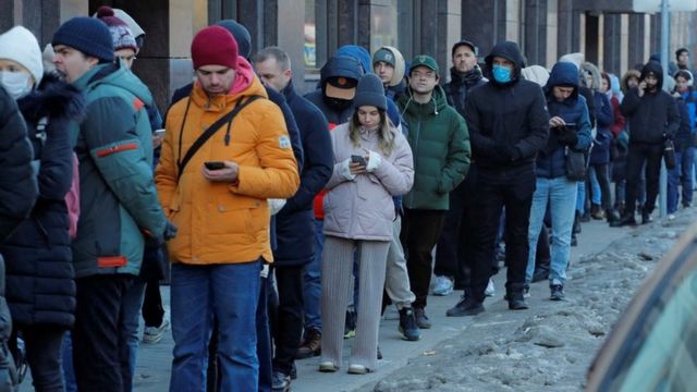 People stand in line to use an ATM money machine in St Petersburg, Russia February 27, 2022