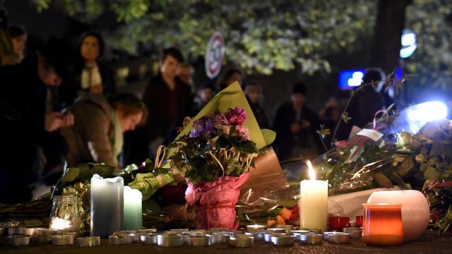 Flowers and candles near the Bataclan concert hall