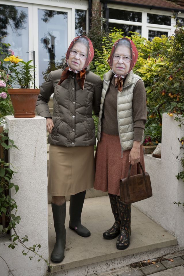 A Briton wears a mask with the portrait of Queen Elizabeth II to attend a community event in south London.  to join the celebration  On the occasion of the Queen's 70th anniversary of the throne