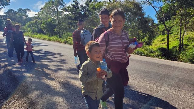 Migrants walk the road