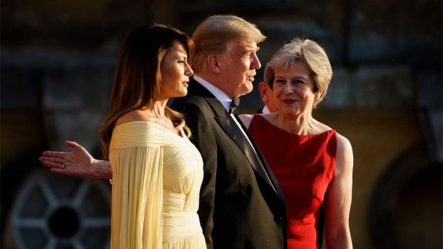 Prime Minister Theresa May directs US First Lady Melania Trump and US President Donald Trump after a ceremonial welcome for a black-tie dinner with business leaders at Blenheim Palace
