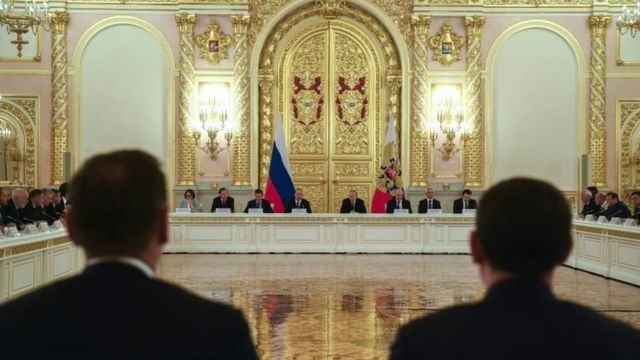 Russian President Vladimir Putin (C-R) attends a meeting with Russian business community at the Kremlin in Moscow, Russia,