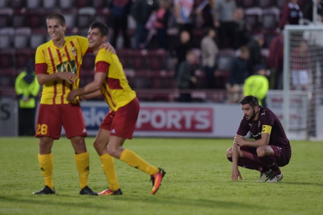 Birkirkara players celebrate as Hearts' Alim Ozturk is left disappointed