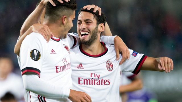 AC Milan forward Andre Silva (L) dey celebrate as im score with midfielder from Turkey Hakan Calhanoglu