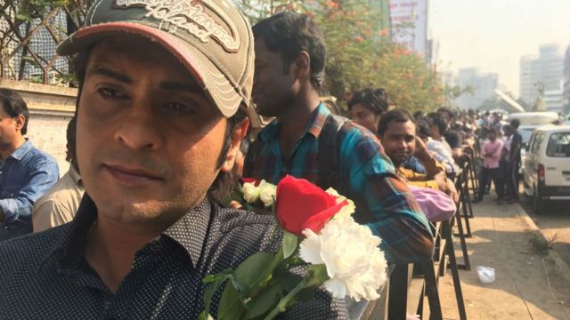 A man waits in queue to pay his respects to the Bollywood star