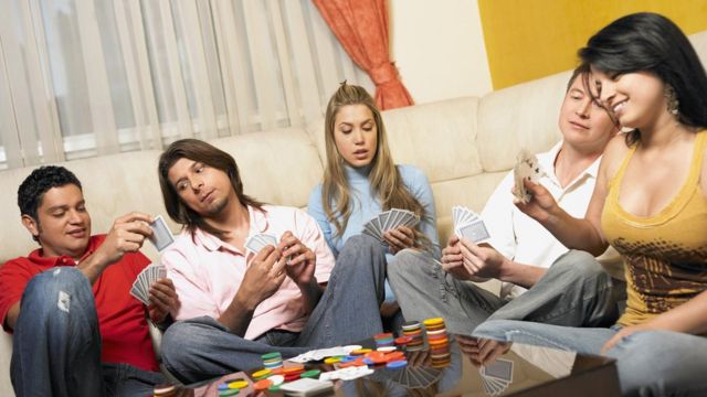 Five people playing cards