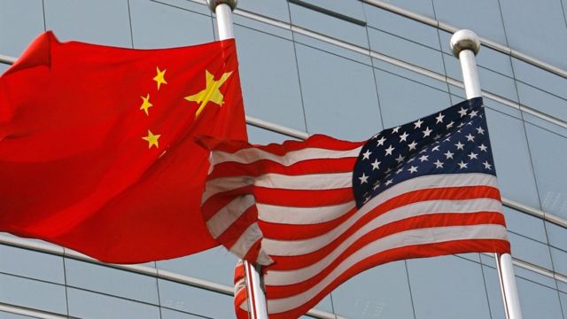 A US and a Chinese flag wave outside a commercial building in Beijing (9 July 2007)
