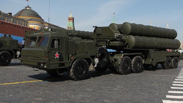 Dark green military truck carries missiles