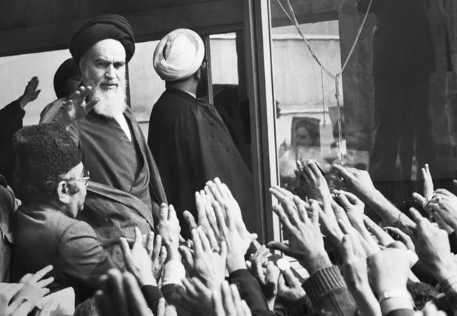 اية الله الخميني يحي انصاره لدى عودته الى إيران عام 1979 بعد الإطاحة بحكم الشاه محمد رضا بهلوي