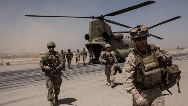US troops walk off a helicopter on the runway at Camp Bost in 2017 in Helmand Province