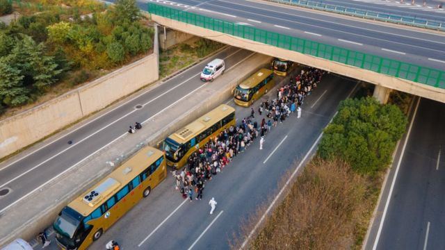 Foxconn employees board buses to take them to hometowns