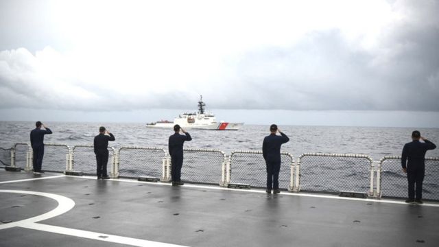 Philippine coast guard personnel aboard Gabriela Silang salute during a passing honour ceremony at the conclusion of a joint search and rescue exercise between the Philippine and US coast guards in the vicinity of the South China sea off Zambales on September 3, 2022. (