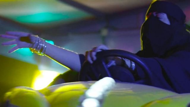 Saudi woman driving a bumper car at a funfair