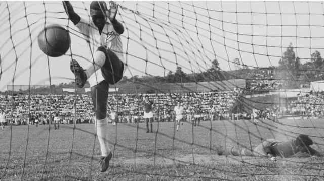 Pele scoring a goal.