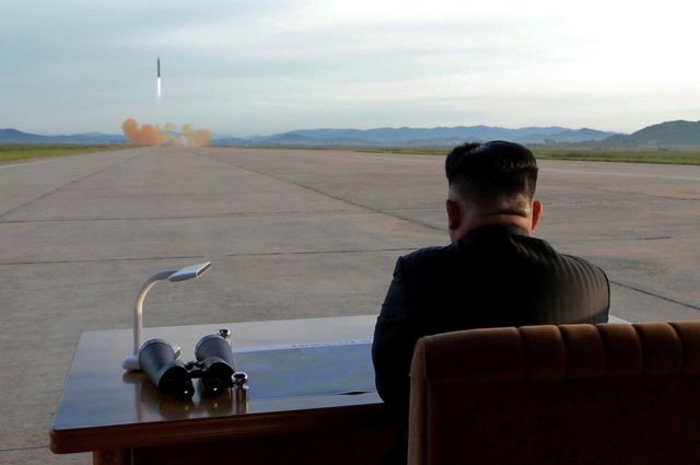North Korean leader Kim Jong Un watches the launch of a Hwasong-12 missile.