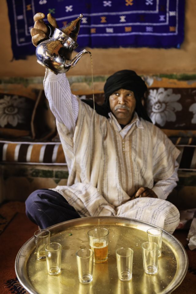 A Moroccan man prepares green tea