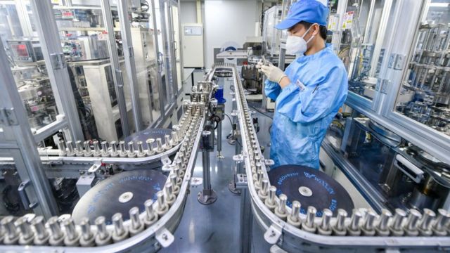 An employee works in a lithium battery production line at a factory belonging to Tianneng Battery Group in Changxing County, Zhejiang Province, China.
