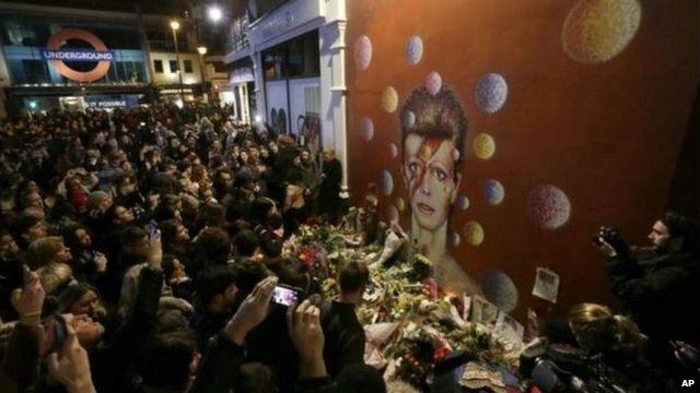 Crowds of fans gathered in tribute to Bowie at a mural in his birthplace of Brixton, south London painted by street artist James Cochran, aka Jimmy C