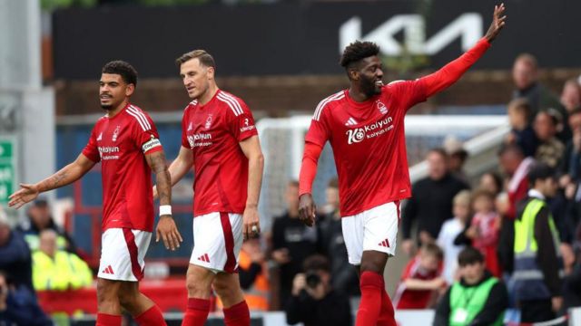 Ibrahim Sangare waves to the crowd after scoring Nottingham Forest's third goal against Chesterfield. Chris Wood and Morgan Gibbs-White are pictured in the background.