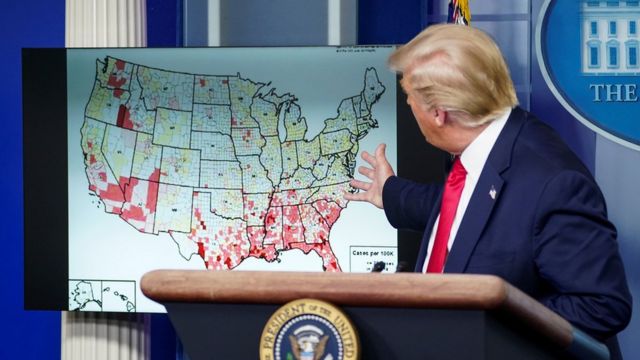 US President Donald Trump points to map of reported coronavirus cases as he speaks about reopening schools during a coronavirus news briefing at the White House in Washington