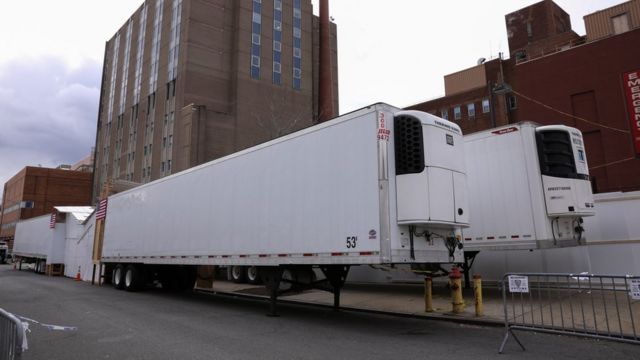 Refrigerated tractor trailers serve as temporary morgues outside the Wyckoff Heights Medical Center in the Brooklyn borough of New York City, New York, 10 April