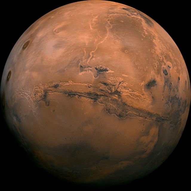 Mars, with dark ridges visible across the centre and to the right