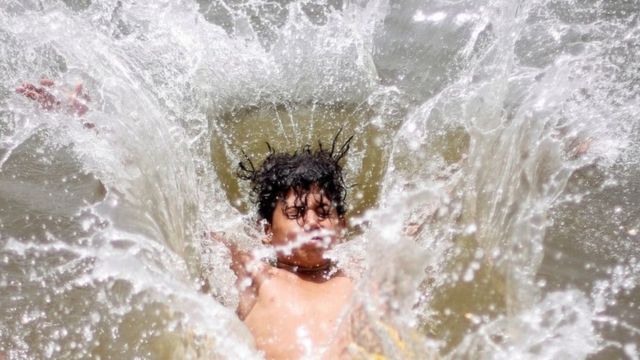 An Egyptian boy jumps into the water to cool off in hot and humid weather during the Muslim holy fasting month of Ramadan in Cairo, Egypt May 23, 2018.