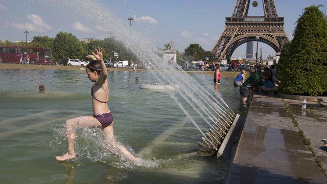 Girl jumping in fountain