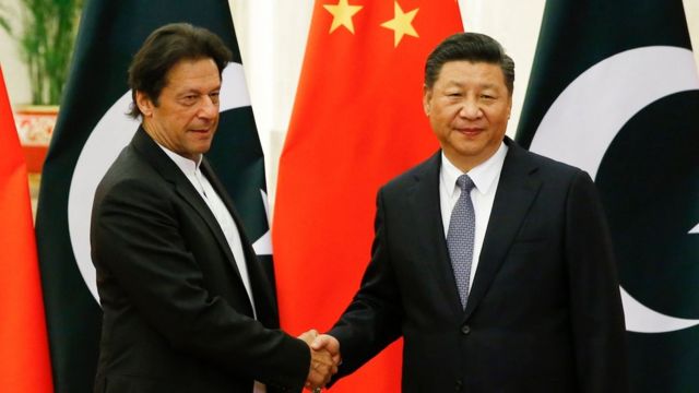 China"s President Xi Jinping (R) shakes hands with Pakistan"s Prime Minister Imran Khan (L) ahead of their meeting at the Great Hall of the People in Beijing on November 2, 2018