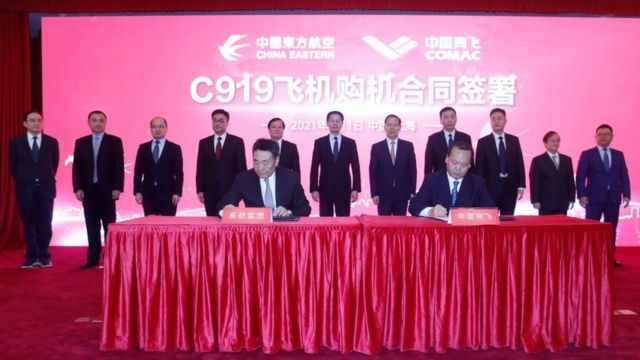 Delegate from China Eastern Airlines and COMAC sign documents during a contracts signing ceremony on March 1, 2021 in Shanghai, China.