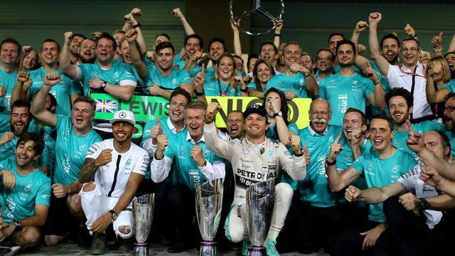 Lewis Hamilton and Nico Rosberg celebrate with the Mercedes team