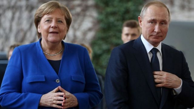 Former German Chancellor Angela Merkel with Russian President Vladimir Putin in Berlin on January 19, 2020.