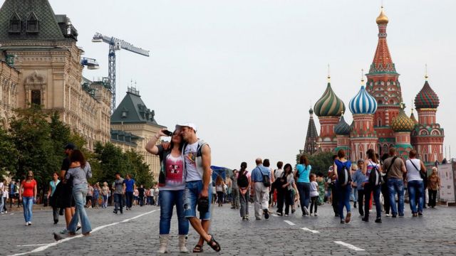 A couple stood in front of St Basil's Cathedral in Moscow's Red Square in Russia.
