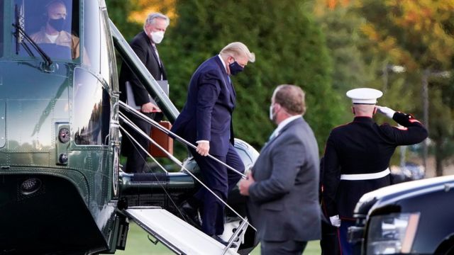 President Donald Trump disembarks from Marine One helicopter as he arrives at Walter Reed National Military Medical Center