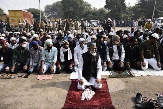المسلمون يؤدون الصلاة تحت حماية الشرطة في غورغاون.