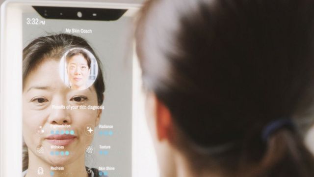 A woman uses a smart mirror