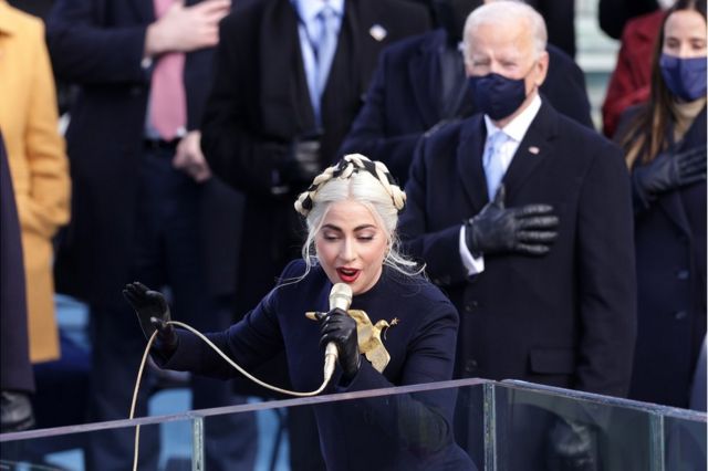 Lady Gaga sings with Joe Biden standing behind her