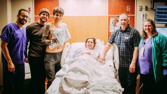 The Eledge and Dougherty family stand with newborn baby Uma.