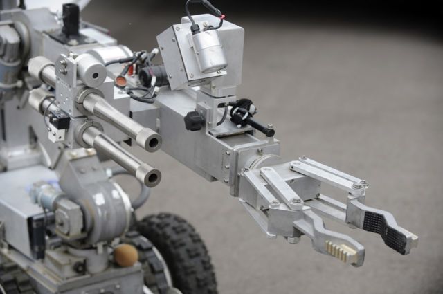 A bomb disposal robot with arm outstretched